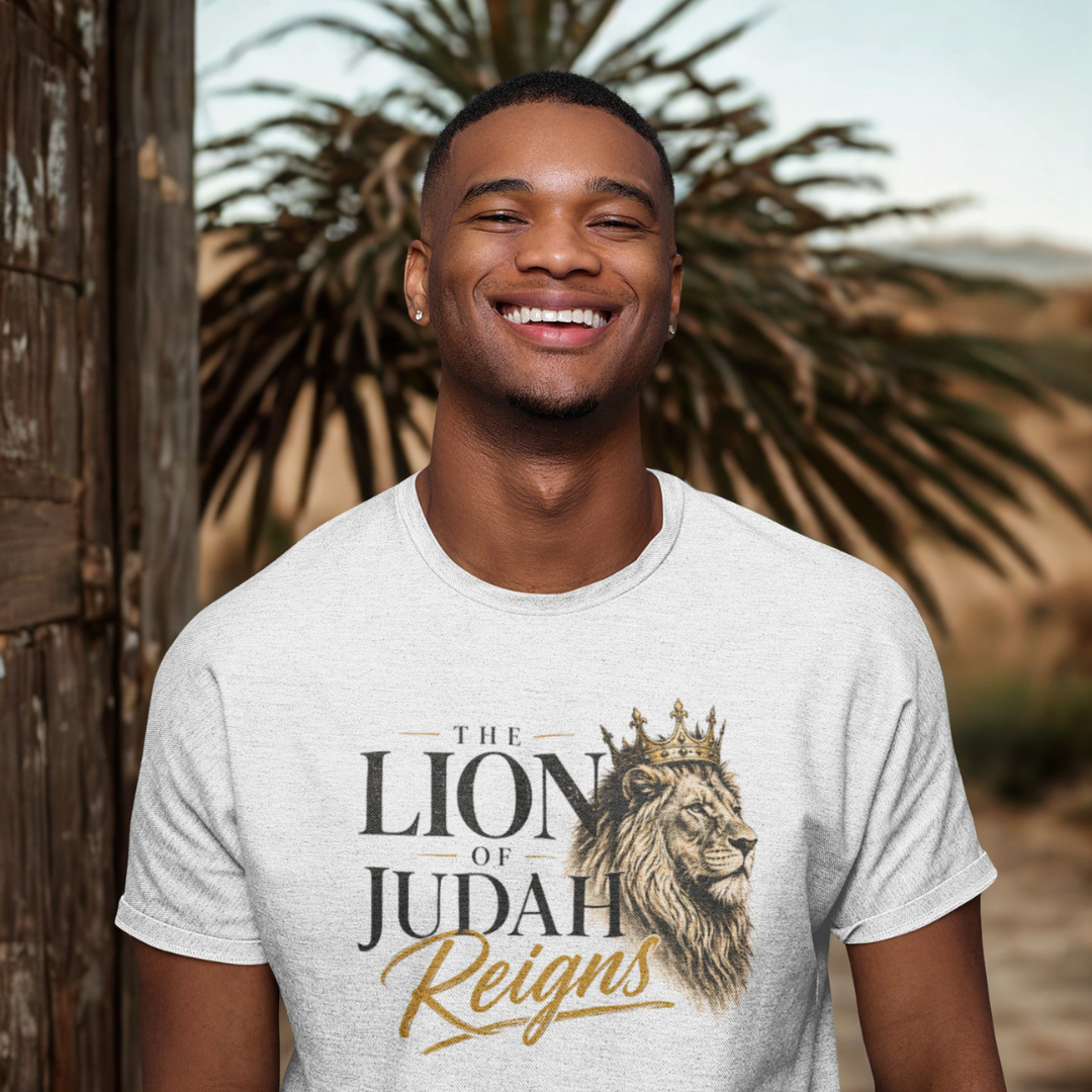 Man wearing a t-shirt with 'The Lion of Judah Reigns' design outdoors.