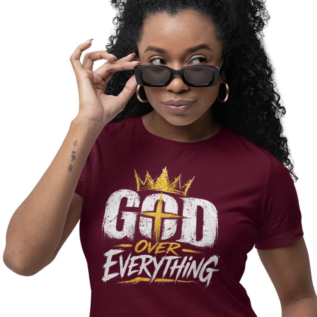 Woman wearing a maroon t-shirt with 'God Over Everything' text and a crown graphic.