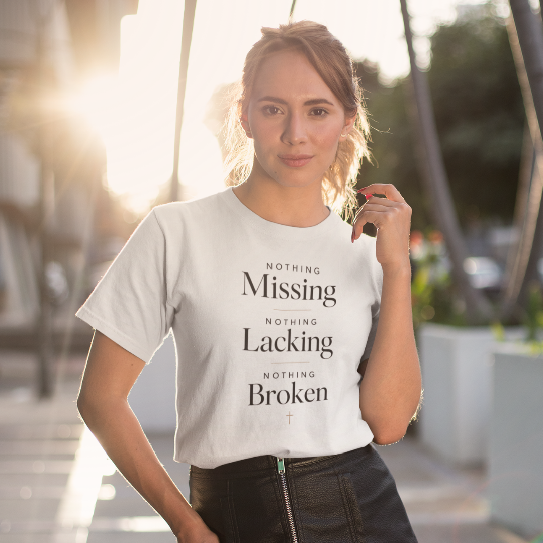 Woman wearing a white t-shirt with text outdoors